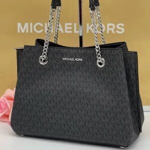 Michael Kors monogram Teagan bag with silver chain handles and hardware.